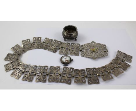 A hallmarked silver manual-wind trench watch (af), an Indian silver open salt with gilt interior and a plated nurses' buckle 