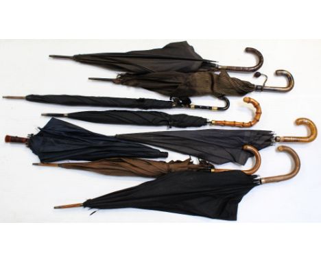 A collection of umbrellas and parasols to include a faux tortoiseshell handled example with gold coloured bright-cut engraved