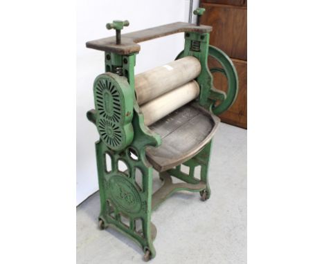 A large cast and wrought iron vintage mangle, height 131cm.