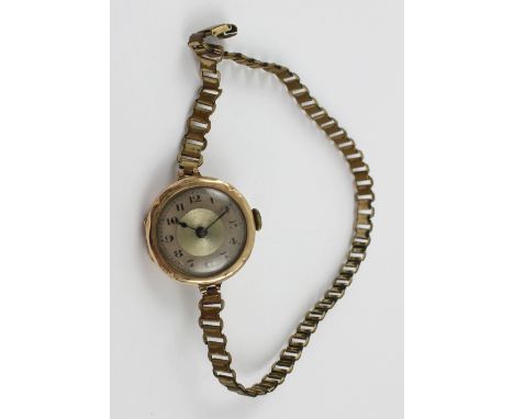 A gold 1930s trench watch, the silvered dial set with Arabic numerals, presented on rolled gold flat link bracelet, diameter 