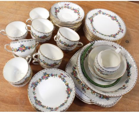 A 1930s twelve-setting part tea service comprising twelve cups, twelve saucers, twelve side plates (one af), six fruit bowls,