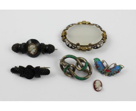 A small group of brooches to include a 19th century pinchbeck pendant-brooch with central oval moonstone bordered with black 