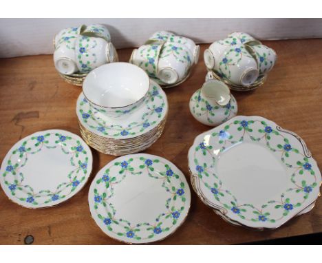 A c1920 Hammersley twelve-setting tea service, hand-decorated in blue and green floral swags, comprising twelve cups and sauc