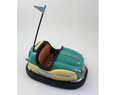 A vintage cassette player in the form of a fairground dodgem car, length 33cm.