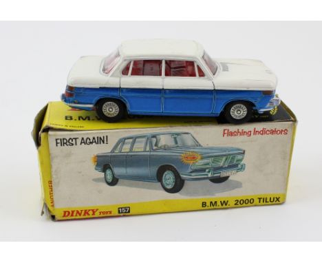 A Dinky Toys 'BMW 2000 Tilux' in two-tone finish of white and metallic blue with red interior, presented in original box with