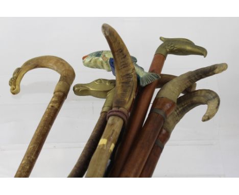 Eight country walking sticks to include a shaped and carved horn crook, one with painted leaping salmon handle and other horn