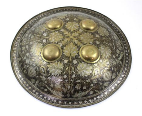 A late 19th/early 20th century Bidrieware shield decorated in silver and gold floral pattern to an arabesque black ground wit
