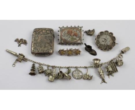 A small group of silver jewellery items to include a silver charm bracelet with multiple charms, a silver filigree Edelweiss 
