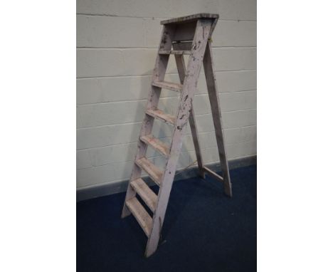 A VINTAGE SET OF WOODEN STEP LADDERS, deep when closed 41cm at widest point (condition:- distressed, paint scuffed worn and c