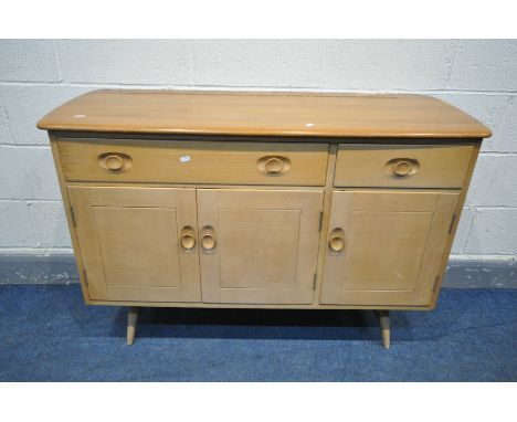 AN ERCOL WINDSOR ELM AND BEECH SIDEBOARD, with two drawers over three cupboard doors, on turned legs united by a single stret