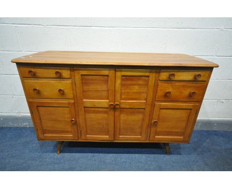 A 1950'S ERCOL ELM SIDEBOARD, with an arrangement of drawers, and cupboard doors, on turned legs united a single stretcher, w