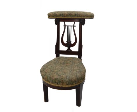 A late 19thC mahogany framed prie dieu chair, with floral upholstered back and carved ram and harp supports, 80cm high. 