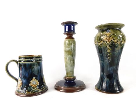 Three items of Royal Doulton stoneware, comprising a blue and green ground stem vase, 18cm high, associated candlestick, 20cm