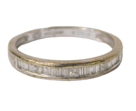 A 9ct white gold diamond half hoop eternity ring, with baguette and round brilliant cut stones totalling 0.25ct, ring size N½