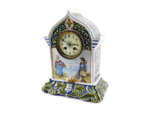 A late 19thC French faience Quimper mantel clock, the arched top polychrome decorated with two fishing figures, with HB stamp