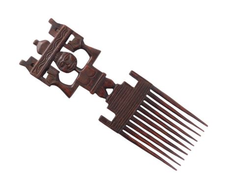 An African hardwood tribal comb, with figural handle, 41cm high. 