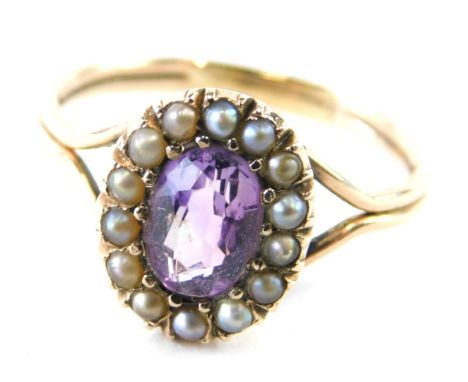 A Victorian amethyst and seed pearl dress ring, the oval stone surround by small pearls, on a part pierced shank, unmarked, s