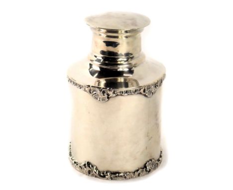 A George V silver tea caddy, with raised relief, scroll and flower design, London 1926, 3.71oz. (AF)
