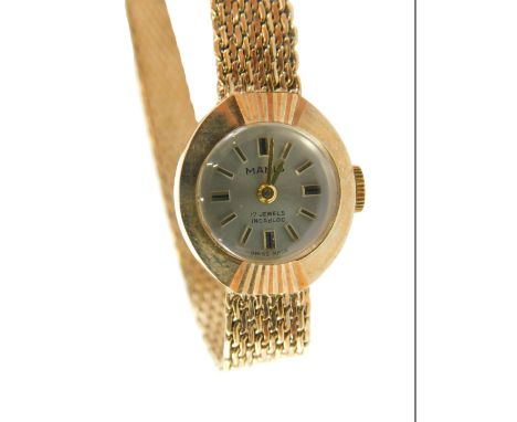 A Manis 9ct cased ladies wristwatch, with a small silvered dial on bark effect bracelet, with fan ring head, 1.5cm wide, 14.5