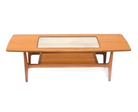 A Schreiber Aeroplane teak coffee table, of tapering form with shaped ends, glass insert and lower shelf, 43cm high, 126cm wi