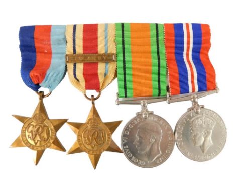 A group of World War II medals, comprising the George VI Defence medal, George VI medal, Africa Star, and the 1939-45 Star, w