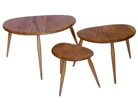 A nest of three Ercol elm and beech pebble shaped tables, lacking labels, the largest 64cm wide.&nbsp;