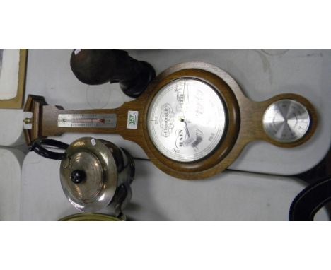 Oak cased barometer: together with a silver plated kettle  and a wooden sculpture (3) 