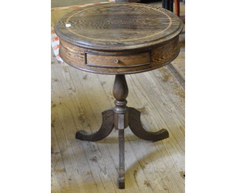 A palm wood drum style table, with single frieze drawer, on tripod base, 53.5 cm diameter