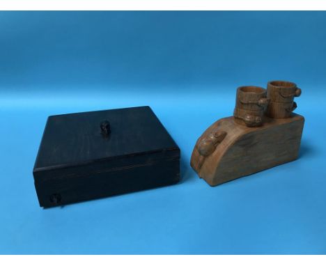 A carved oak napkin ring stand and napkin rings and a box