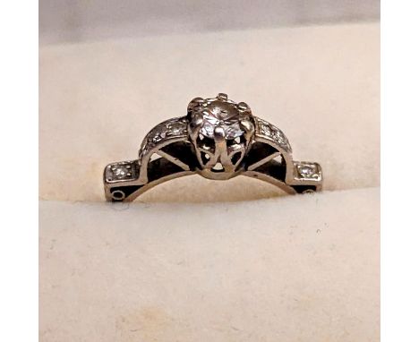 An Art Deco diamond ring, stamped Plat, 3.6g, size 'O', central stone approx. 0.5ct, 1.25cts total