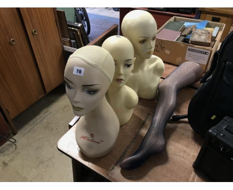 Three mannequin heads and a leg