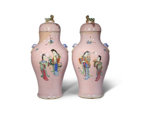A PAIR OF CHINESE FAMILLE ROSE PINK-GROUND VASES AND COVERS 19TH CENTURY Each brightly painted with two ladies and a lion dog