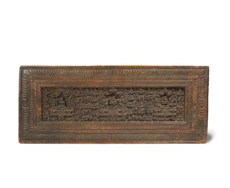 A RARE TIBETAN CARVED WOOD BOOK COVER 14TH CENTURY Decorated with three Buddhist figures elevated on elaborate thrones with m