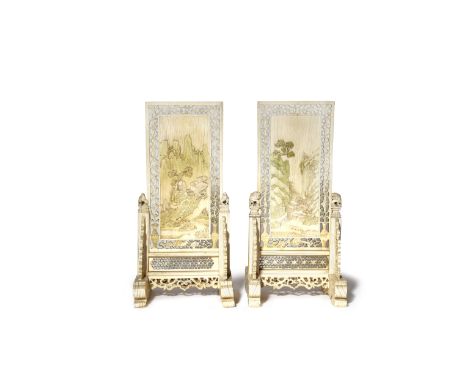 A PAIR OF CHINESE IVORY TABLE SCREENS QING DYNASTY Each carved in shallow relief with a scene of houses amidst trees in a roc