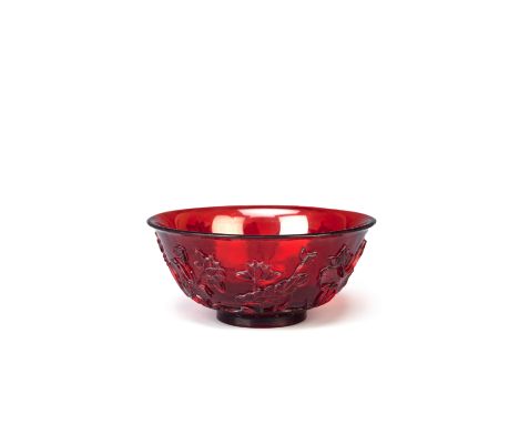 A CHINESE BEIJING RUBY-GLASS BOWL 18TH CENTURY Carved in relief with a single standing water bird amidst lotus growing from r