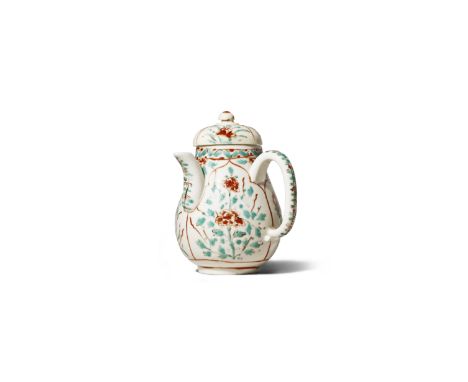 A CHINESE DEHUA CHOCOLATE POT AND COVER KANGXI 1662-1722 The pear-shaped body later decorated with shaped panels of stylised 