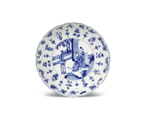 A CHINESE BLUE AND WHITE LOTUS MOULDED DISH SIX CHARACTER KANGXI MARK AND OF THE PERIOD 1662-1722 Painted to the centre with 