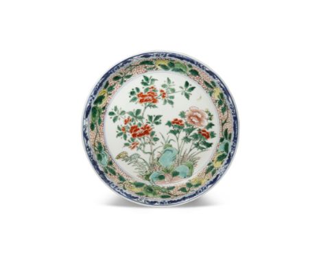 A CHINESE FAMILLE VERTE DISH KANGXI 1662-1722 Painted in coloured enamels with blossoming flowers growing amidst rockwork, th