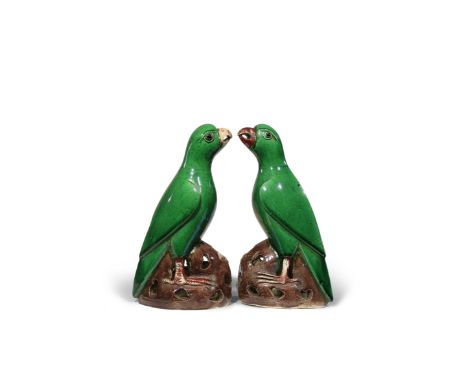 A PAIR OF CHINESE GREEN GLAZED MODELS OF PARROTS KANGXI 1662-1722 Each with its beak slightly open and its wings folded back 