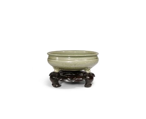 A CHINESE LONGQUAN CELADON TRIPOD INCENSE BURNER MING DYNASTY The compressed shallow bowl incised with flowerheads on a trell