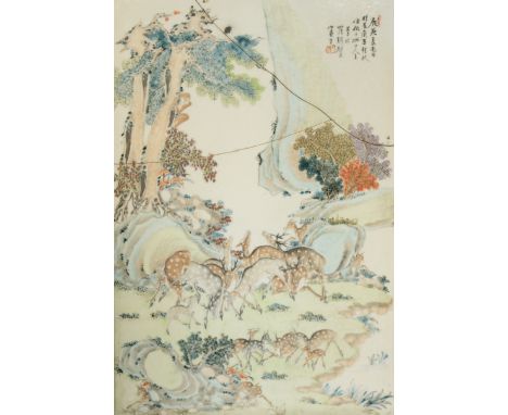 A CHINESE PORCELAIN PLAQUE LATE QING DYNASTY/REPUBLIC PERIOD Painted with a group of deer and their playful fawns amongst roc