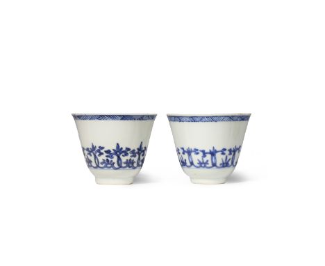 TWO CHINESE BLUE AND WHITE CUPS KANGXI 1662-1722 Each decorated with a band of stylised scrolling foliage to the gently flari