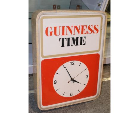 A mid century vintage 'Guinness' electric point of sale advertising clock with backlight that displays "Guiness Time", salvag