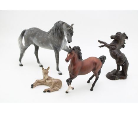Horse ornaments to include Beswick matte brown Prancing Arab, a Wade Northlight figure, a bronze effect rearing horse and a C