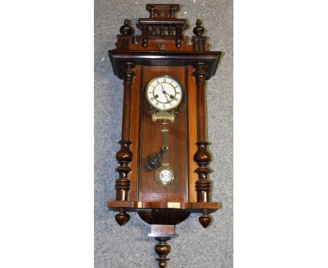 A Vienna wall clock, white ceramic dial, original key and pendulum, Height 95cm.  Collection only on this item.