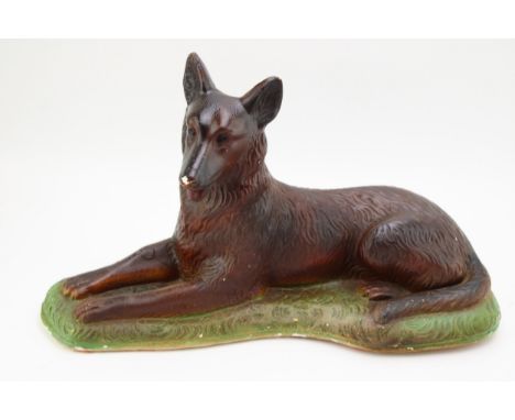 An Art Deco chalk ware figure of an Alsatian / German Shepherd. Height 24cm, width 42cm.  Generally good and presents well so