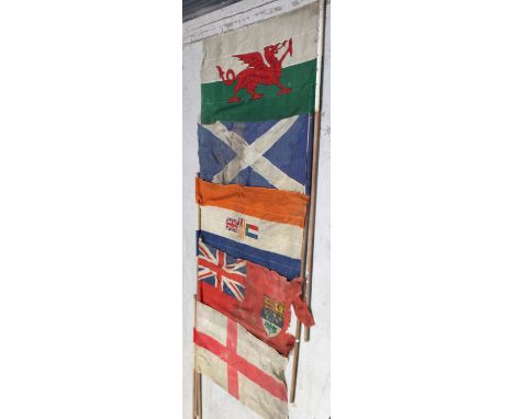 A set of five assorted vintage flags on poles (5).