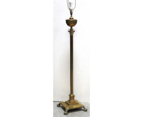 A brass and copper standard lamp, the central Corinthian modelled column raised on square base to ball and claw feet, height 