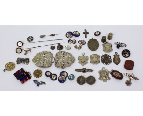 A vintage Meggezones tin containing a small quantity of vintage enamelled buttons and buckles, a white metal nurses' belt, a 