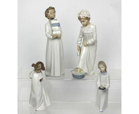 Four Nao figures; a choir boy carrying hymn books, a lady in a nightdress (af), a little boy carrying a candle and a small gi